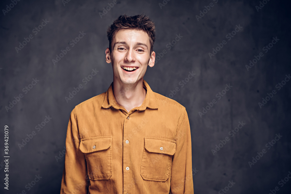 Happy young caucasian man on dark background