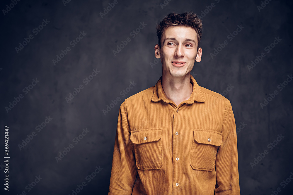 Smiling young caucasian man on dark background