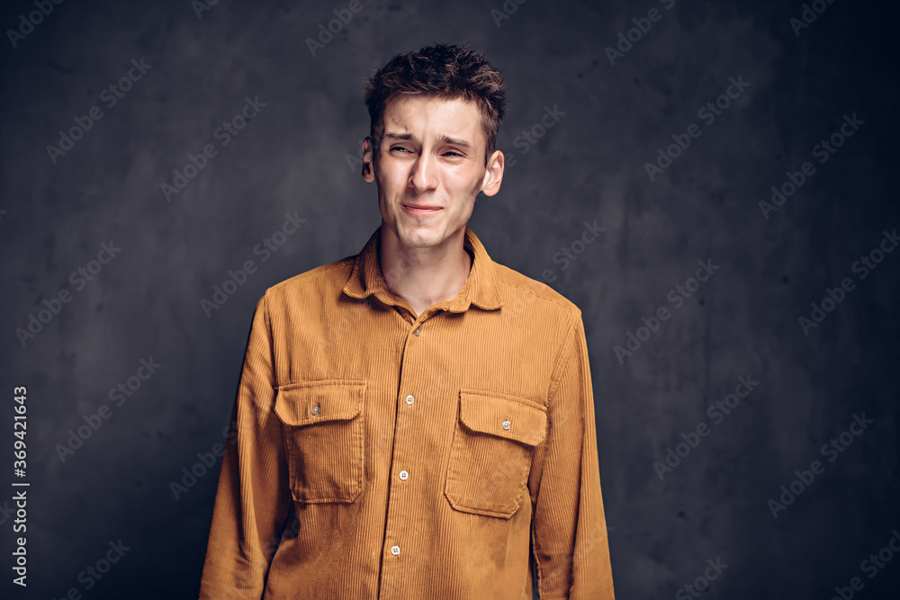 caucasian man with headache on dark background