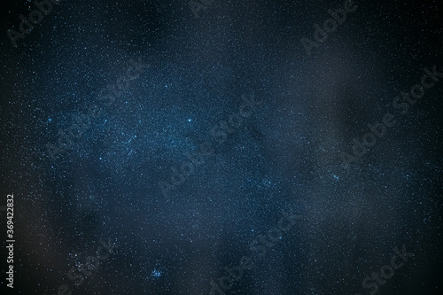 Milky Way Galaxy Glowing Through The Light Cloudiness Overcast. Real Night Sky Stars. Natural Starry Sky Dark Black Background Backdrop © Grigory Bruev