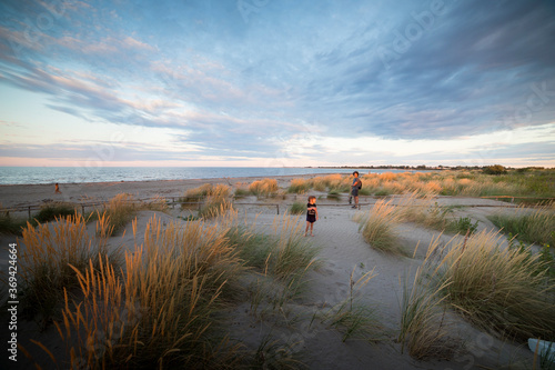 Young father and little daughter in Porto Caleri coastal botanical garden and wild beach at sunset  Veneto  Italy.