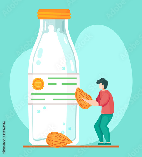 Guy with almond in hands. Concept of almond milk in plastic or glass closed bottle. Organic natural milk product. Man preparing organic free diary drink. Nut milk, vegan milk concept, lactose free