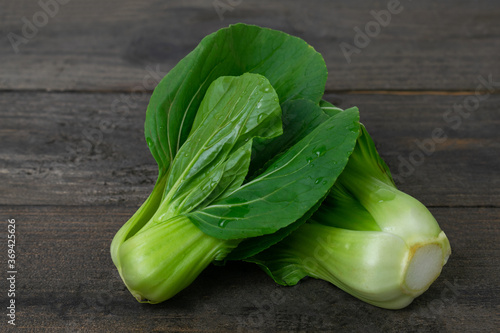 Fresh baby Bok choy on wooden table.