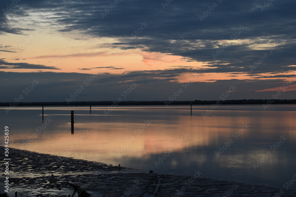 Long exposure golden sunset over Breydon Water, a stretch of the River Yare at Great Yarmouth, Norfolk, UK