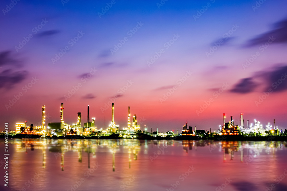 Bangchak Oil Refinery, a view of oil refinery along Chaopraya river at sunrise with reflection in the water, Bangkok, Thailand