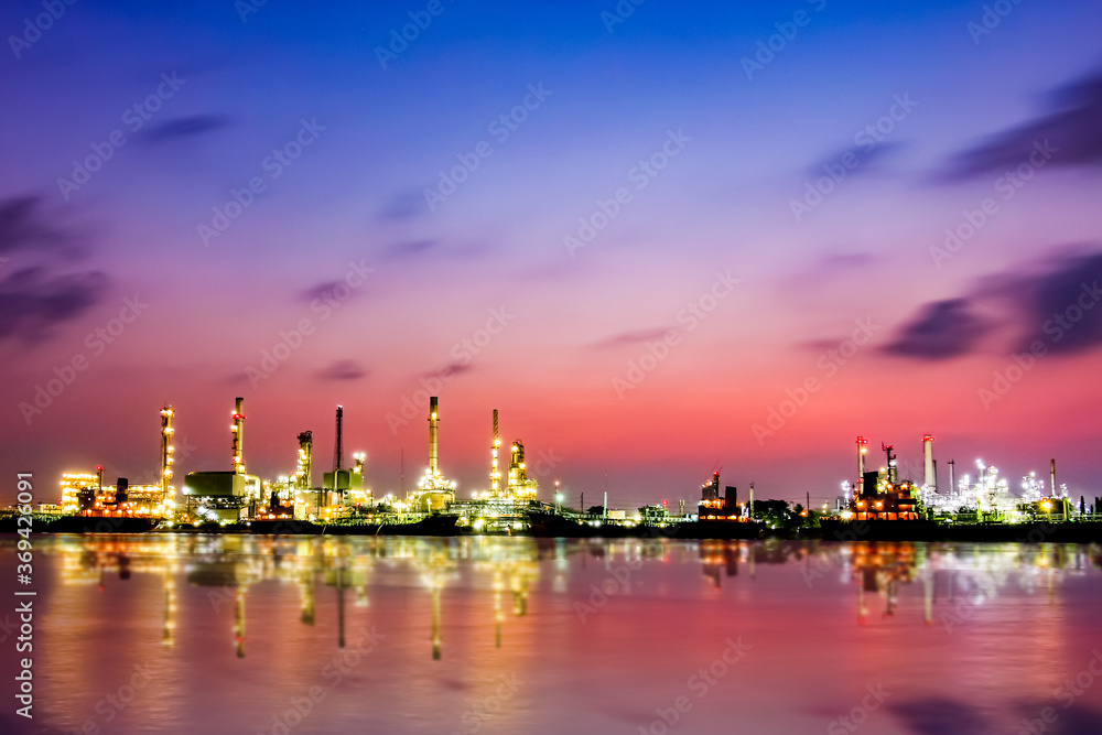 Bangchak Oil Refinery, a view of oil refinery along Chaopraya river at sunrise with reflection in the water, Bangkok, Thailand Bangchak Oil Refinery, a view of oil refinery along Chaopraya river at sunrise with reflection in the water, Bangkok, Thailand