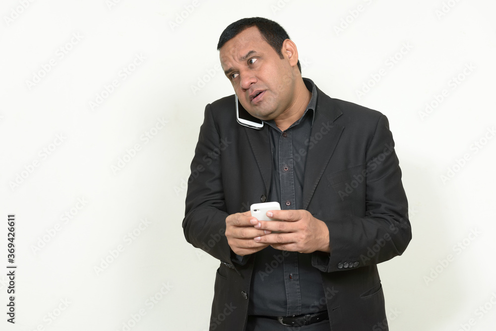Portrait of Indian businessman in suit with phone Portrait of Indian businessman in suit with phone