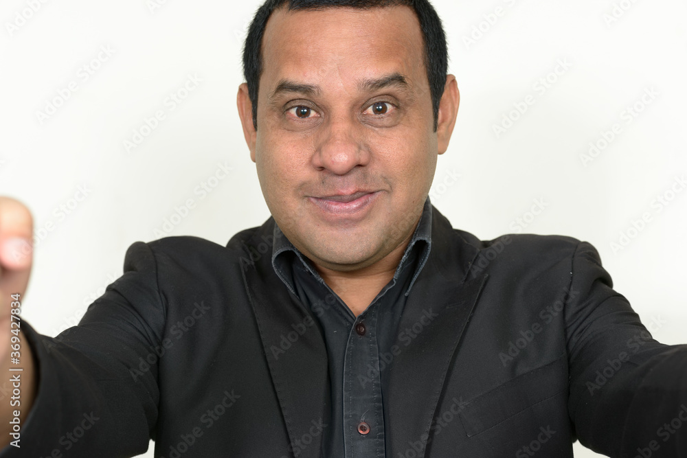 Portrait of Indian businessman in suit taking selfie Portrait of Indian businessman in suit taking selfie