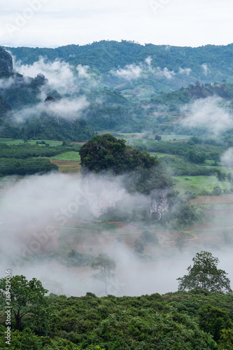 Landscape image of foggy greenery rainforest mountains and hills