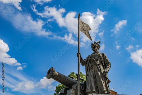 Kharkiv, Ukraine - July 20, 2020: The bronze statue of the great otaman Ivan Sirko in Kharkov against a blue cloudy sky closeup. Zaporizhzhia Army’s outstanding military leader monument with a cannon