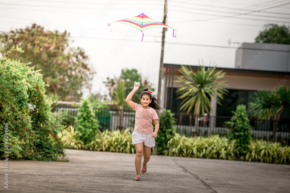 Close-up view of cute girl playing with sports (kite sport), learning outside the classroom during the summer semester and making good use of leisure time.