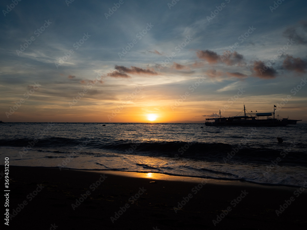 Stunning sunrise over the beach in Philippines. Diving boats waiting for early morning divers. Stunning sunrise over the beach in Philippines. Diving boats waiting for early morning divers.