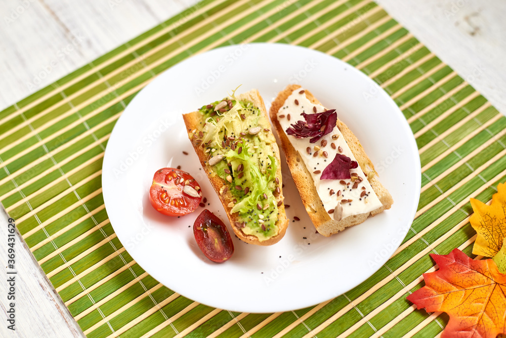 Toasted baguette with avocado and cheese.