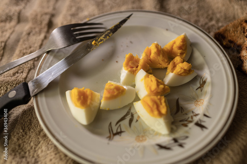 Closeup of white plate with hard boiled eggs. Breakfast food