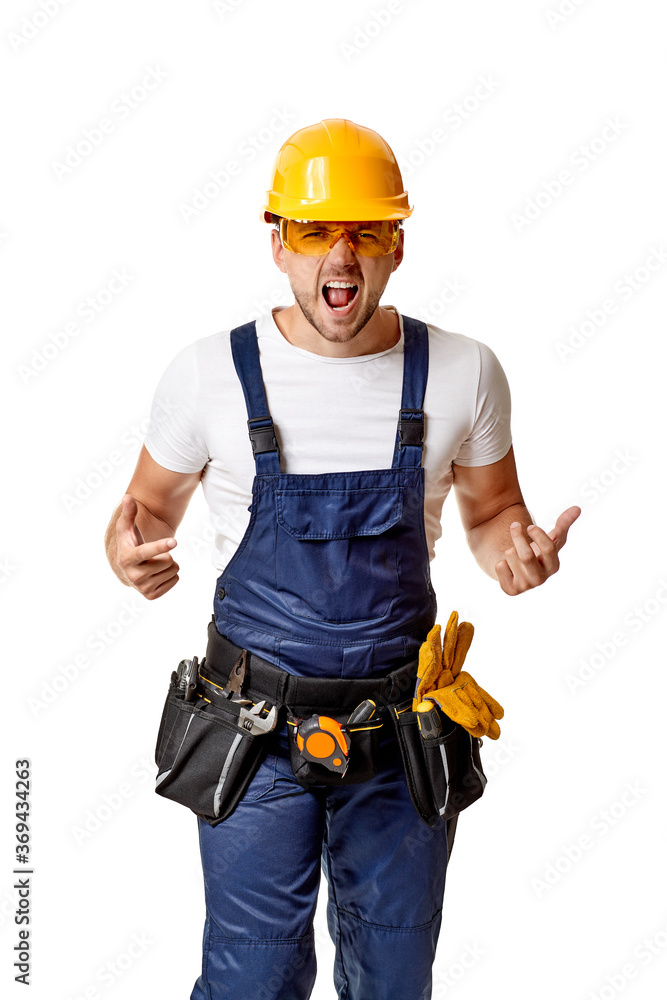 angry caucasian repairman worker in yellow hard hat and uniform. handyman wearing tool belt isolated on white studio background angry caucasian repairman worker in yellow hard hat and uniform. handyman wearing tool belt isolated on white studio background