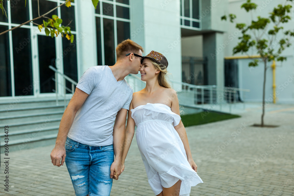 Couple With Pregnant Wife walking in a city street