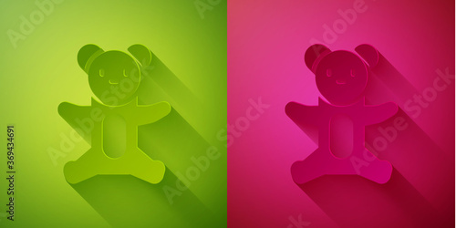 Paper cut Teddy bear plush toy icon isolated on green and pink background. Paper art style. Vector.