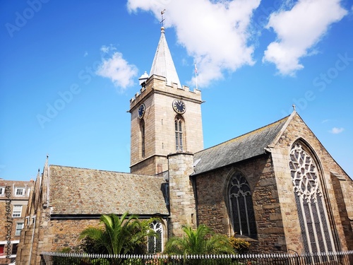 The Town Church is also known as the - Parish Church of St Peter Port in Guernsey with a pedestrian zone near the town square. photo