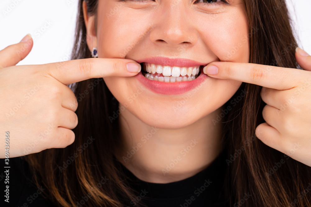 Pretty woman stretching the corners of her mouth and making smile Pretty woman stretching the corners of her mouth and making smile