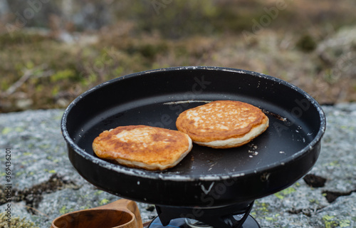 Frying food outdoors with camping kitchen gear, using gas and hiking frying pan