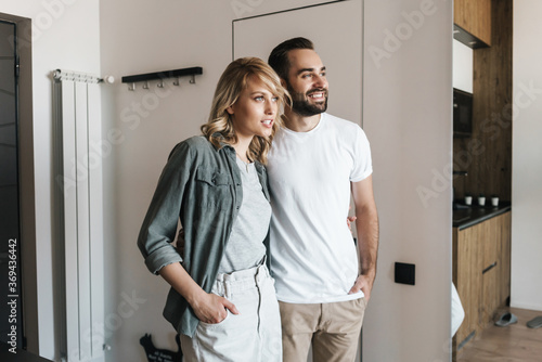 Loving couple standing together indoors at home