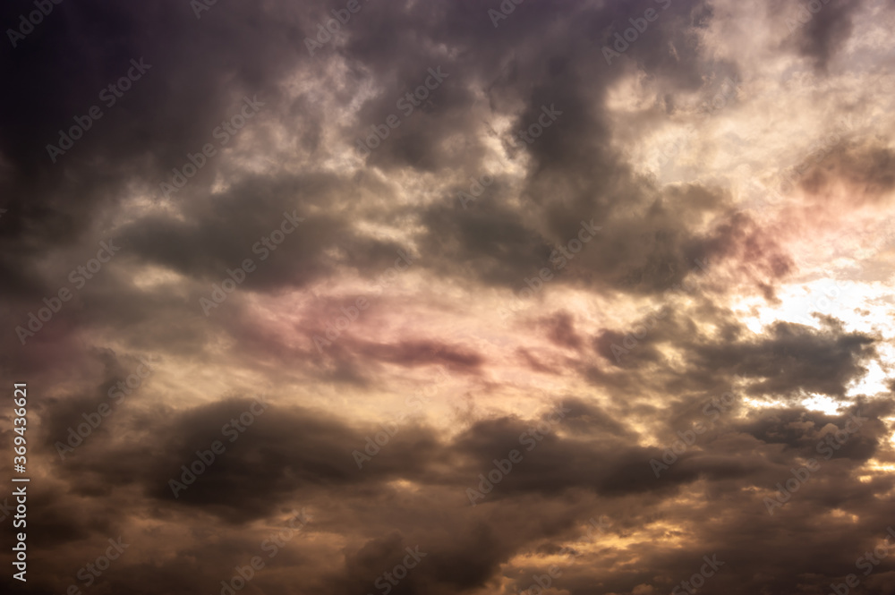 Natural sky composition. Dark ominous colorful storm rain clouds. Dramatic sky. Overcast stormy cloudscape. Thunderstorm. Element of apocalypse design. Toned.