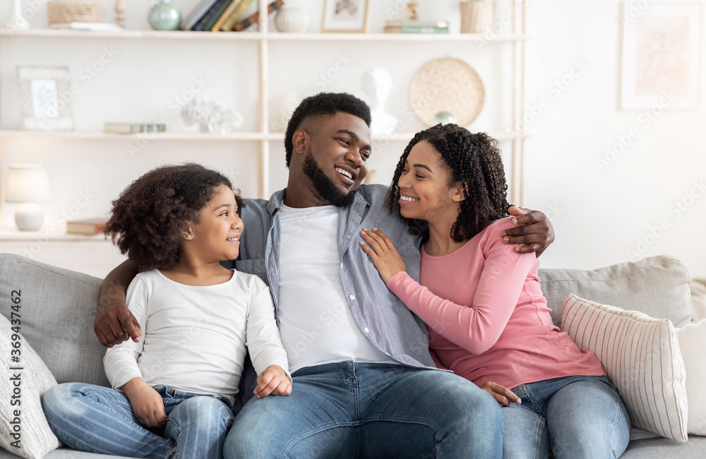 Family Home Leisure. Happy Black Parents And Little Daughter Relaxing On Couch
