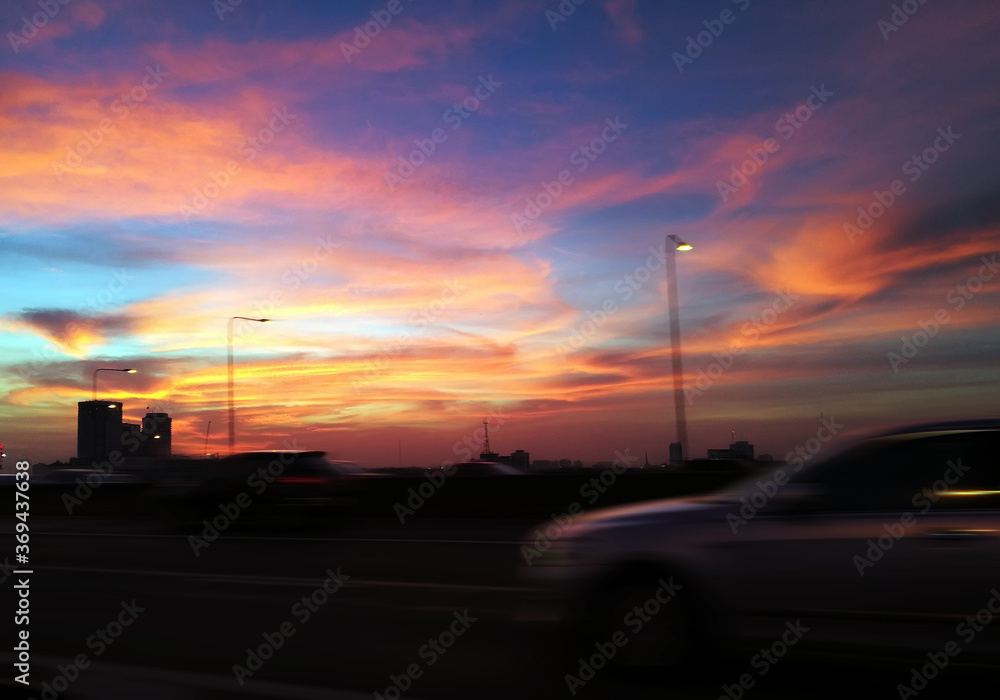 real sunset on twiglight vanilla sky on road and moving