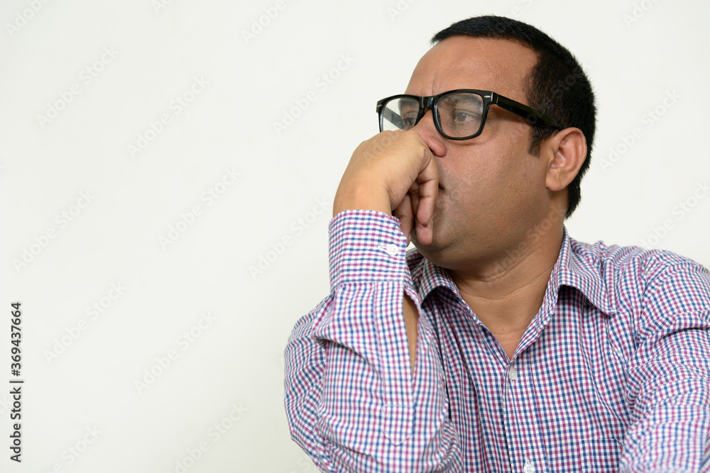 Portrait of overweight Indian businessman with eyeglasses Portrait of overweight Indian businessman with eyeglasses