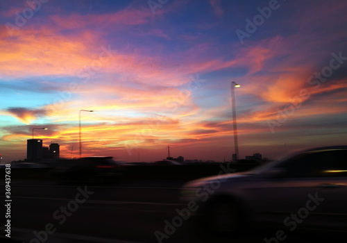 real sunset on twiglight vanilla sky on road and moving