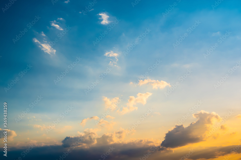 Beautiful soft blue summer sky with clouds at sunset as a background