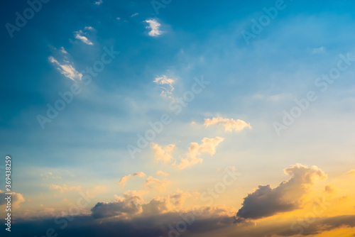 Beautiful soft blue summer sky with clouds at sunset as a background