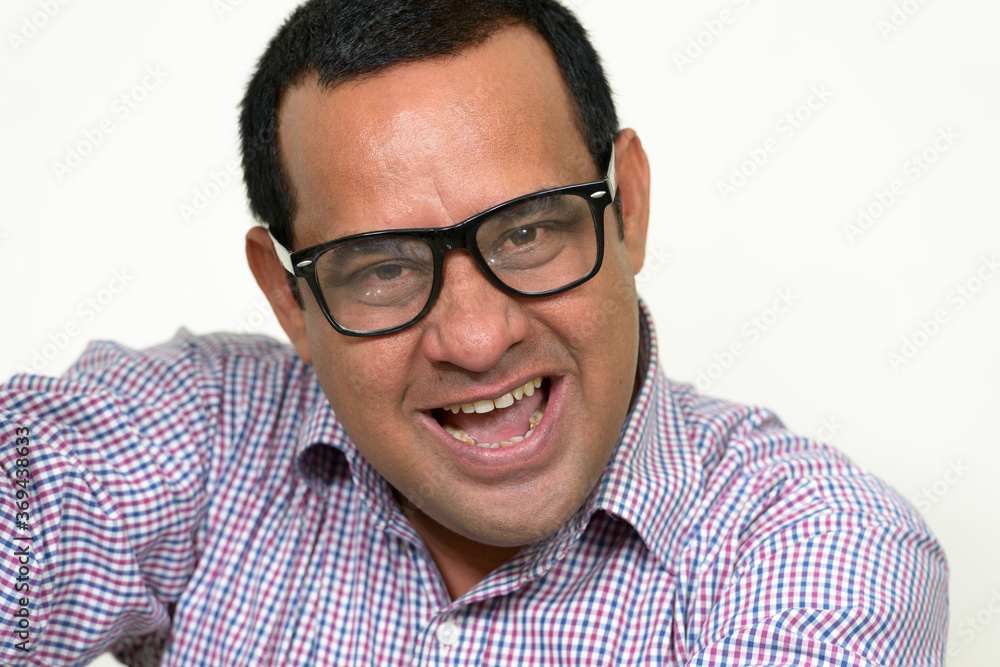 Portrait of happy overweight Indian businessman with eyeglasses