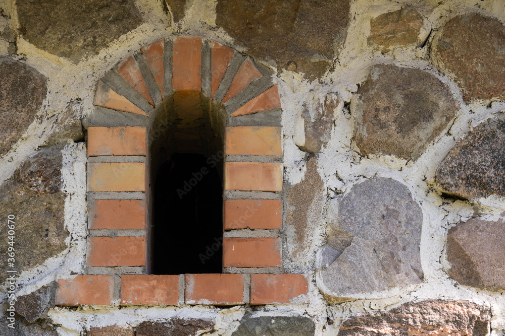 small brick window in a stone wall small brick window in a stone wall