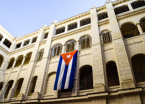 HAVANA, CUBA - MARCH 8, 2017: Bottom-up view of the building of Revolution Museum from its inner courtyard. There is a cuban flag hanging from the wall.