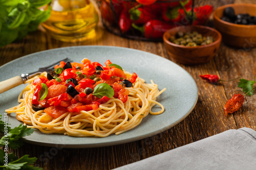 Italian spaghetti alla Pultanesca with tomatoes and olives. Served without meat and cheese.