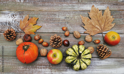 Autumn background. Autumn leaves,cups, and pumpkin on wooden background.