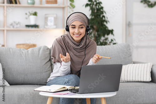 Online Tutoring. Young muslim woman teacher having video call with students photo