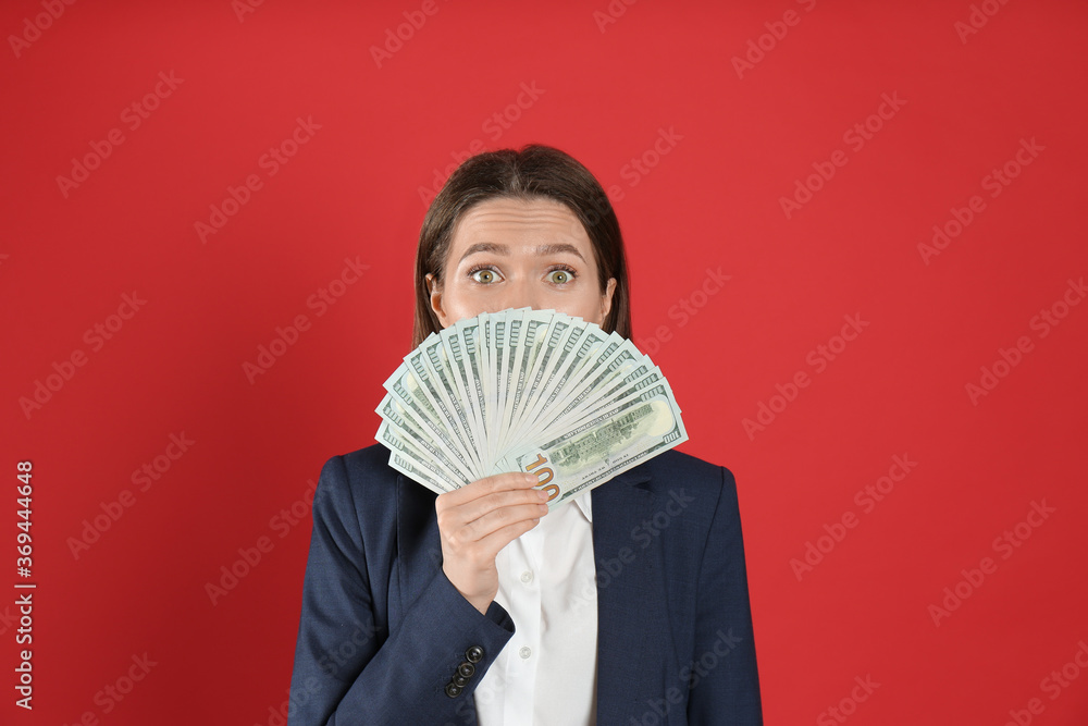 Young woman with money on crimson background Young woman with money on crimson background