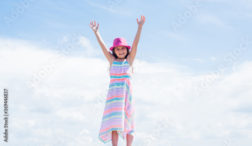 Young and beautiful. stylish cute child posing in spring. Summer fun and leisure concept. fashion model posing. her trendy style. sense of freedom. Stylish fashion child baby girl kid outdoor