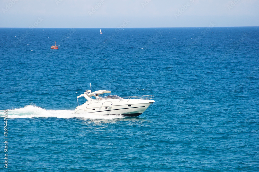Antalya, Turkey, may 23, 2020. White motor yacht on the waves of the blue a sea