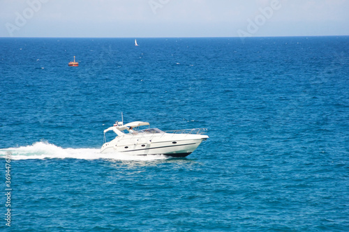 Antalya, Turkey, may 23, 2020. White motor yacht on the waves of the blue a sea