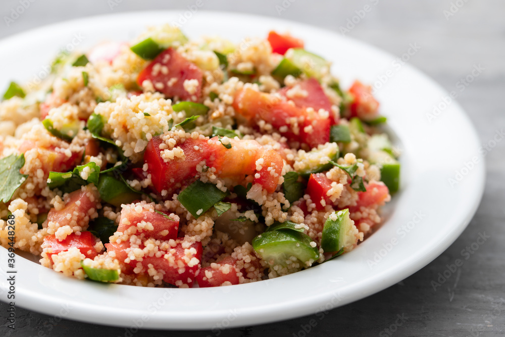 fresh vegetable salad with couscous on white plate fresh vegetable salad with couscous on white plate