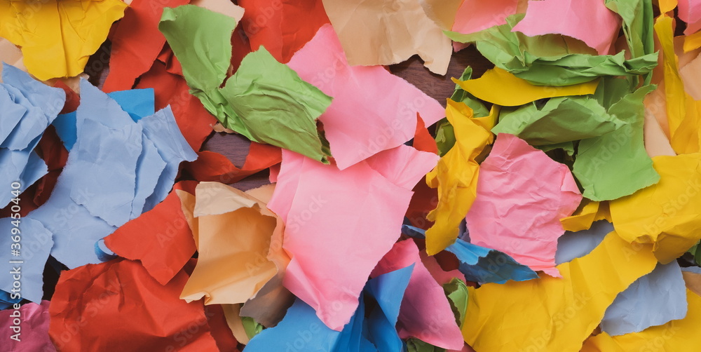 torn and crumpled color papers on a table