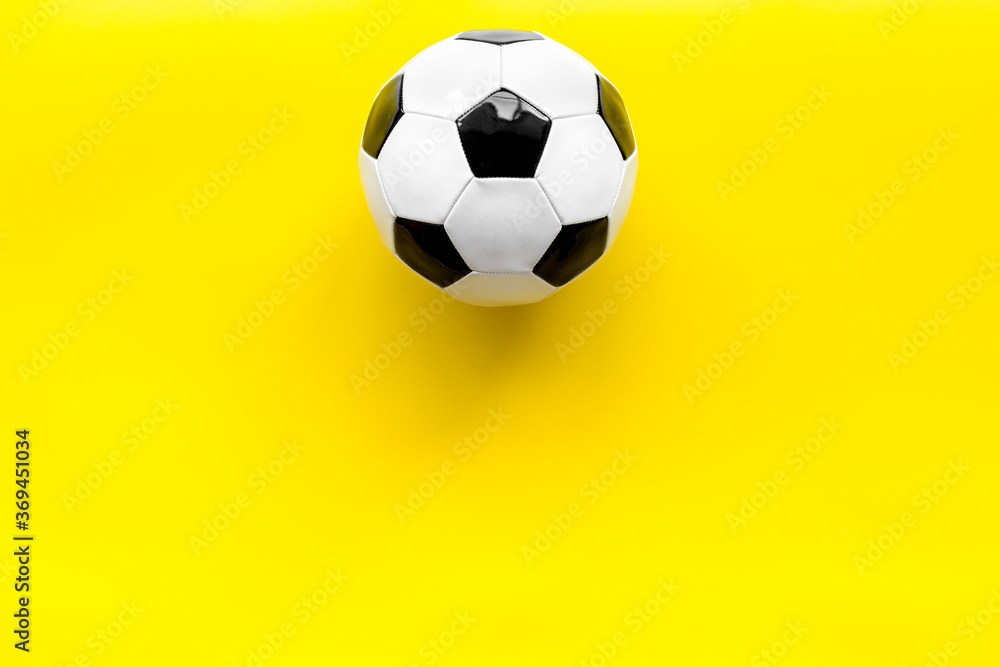 Soccer ball on yellow background top view copy space Soccer ball on yellow background top view copy space