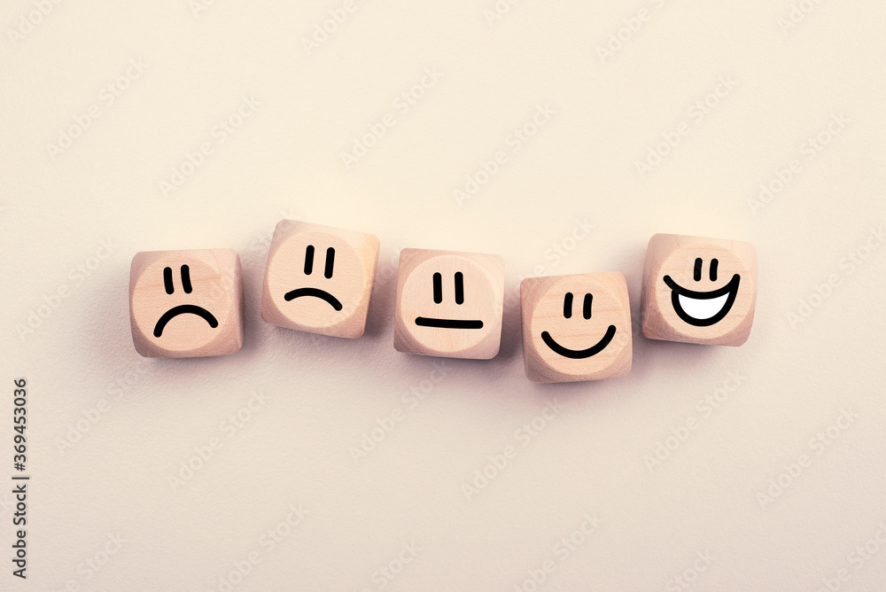 Wooden cubes with rating emotion faces from dissatisfied to happy Wooden cubes with rating emotion faces from dissatisfied to happy