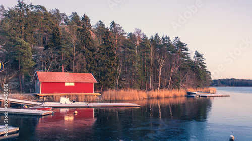 rotes Bootshaus auf Vaxholm in Abendrot photo
