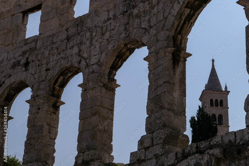 ancient Colosseum Arena in Pula with church in the window