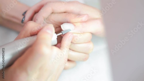 the manicure master cuts off the gel Polish on the client's hands. High quality FullHD footage