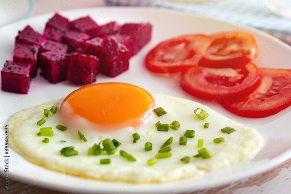Egg, dragon fruit, tomatoes, for breakfast. Close up. Egg, dragon fruit, tomatoes, for breakfast. Close up.